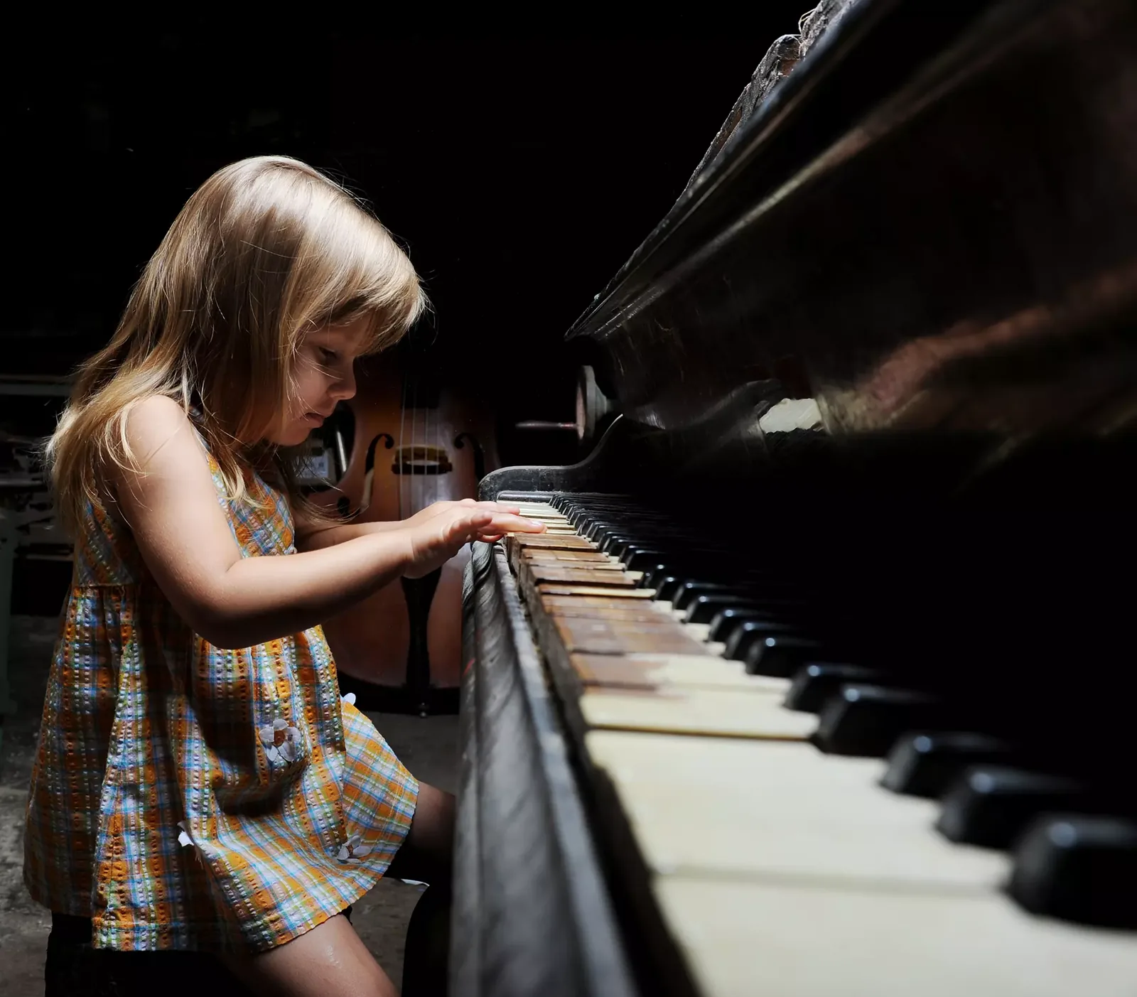 A young musician playing a piano.