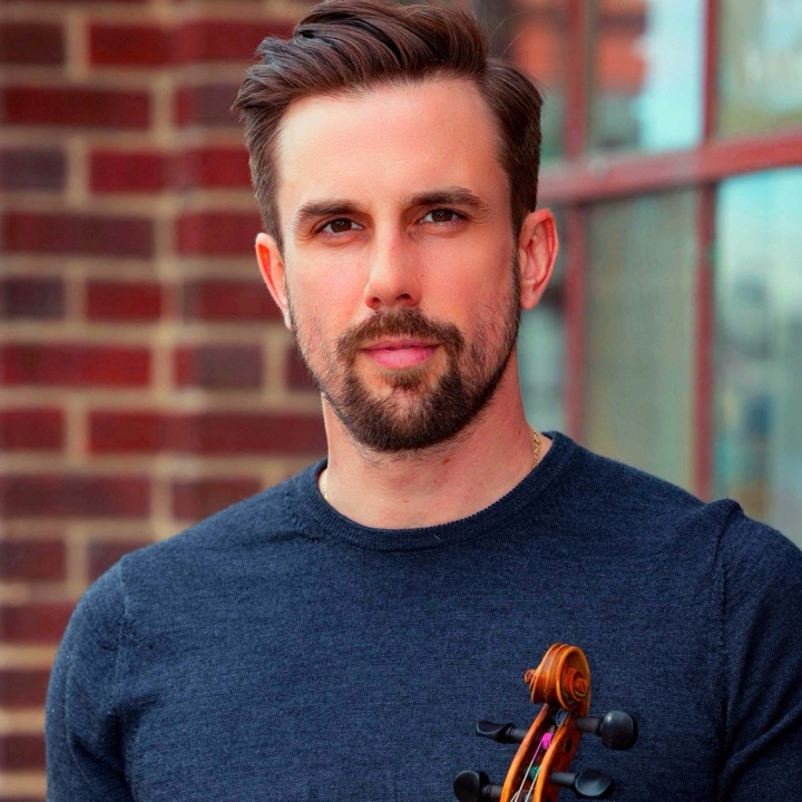 Louis-Pier Racicot, owner of Music 4 Humans, holding a violin