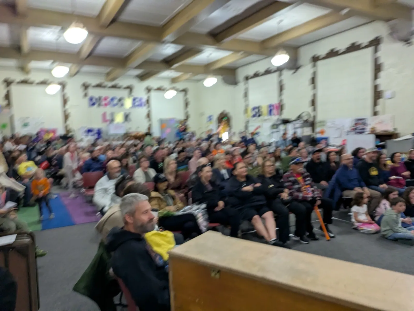 Families filling a school hall to watch the class perform